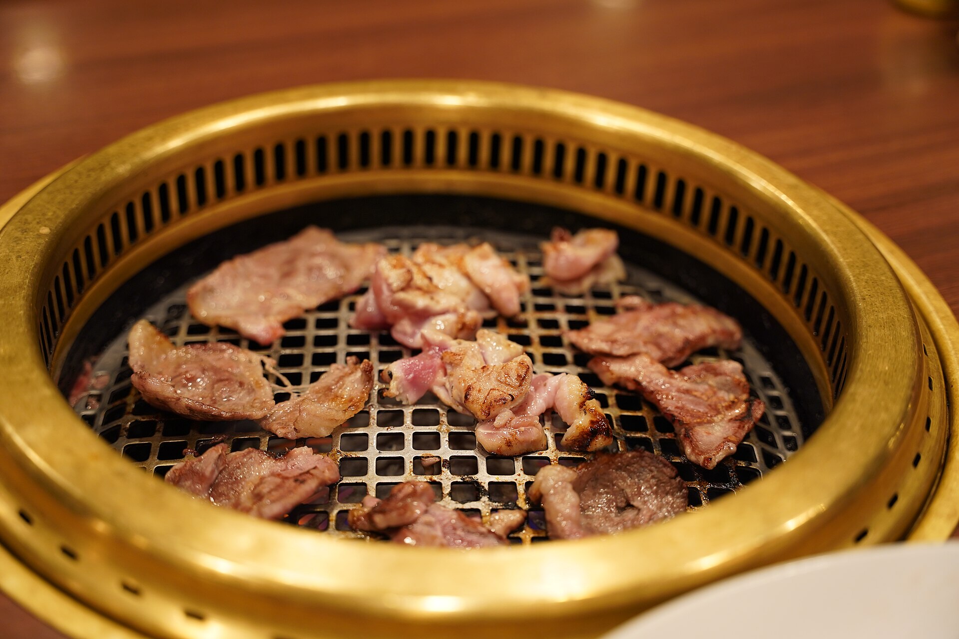 Yakiniku-style tabletop grill with food over heat